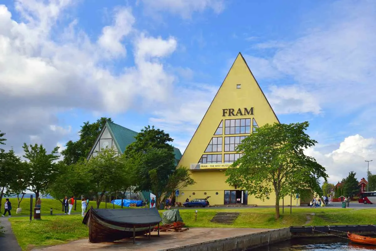 Fram Museum in Oslo with its iconic triangular building under a partly cloudy sky.
