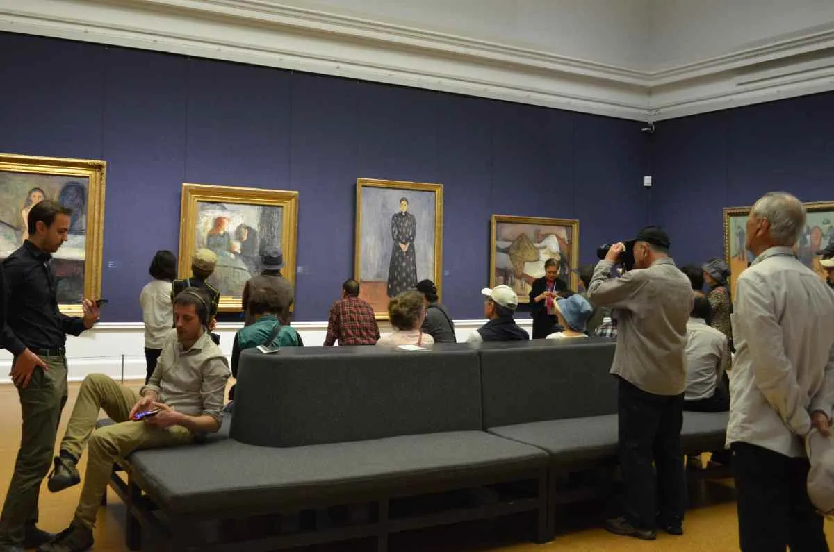 Visitors observing Edvard Munch’s paintings inside the Munch Museum in Oslo.