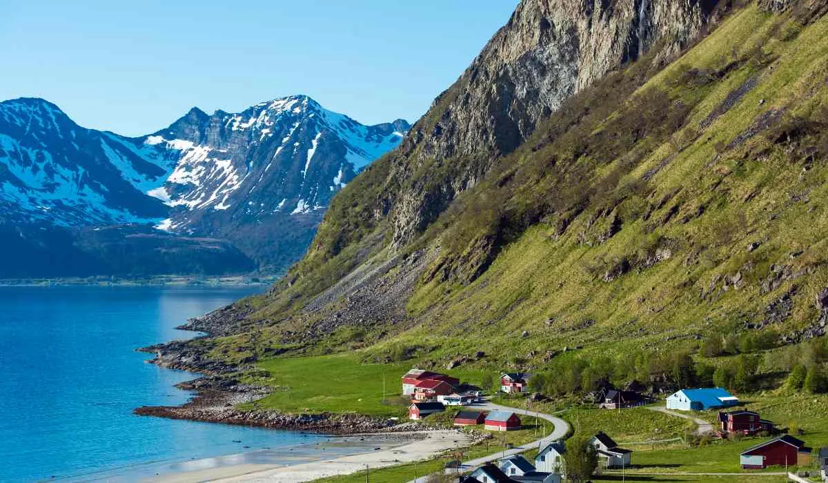 Scenic fjord landscape with colorful houses and snow-capped peaks in Tromsø.