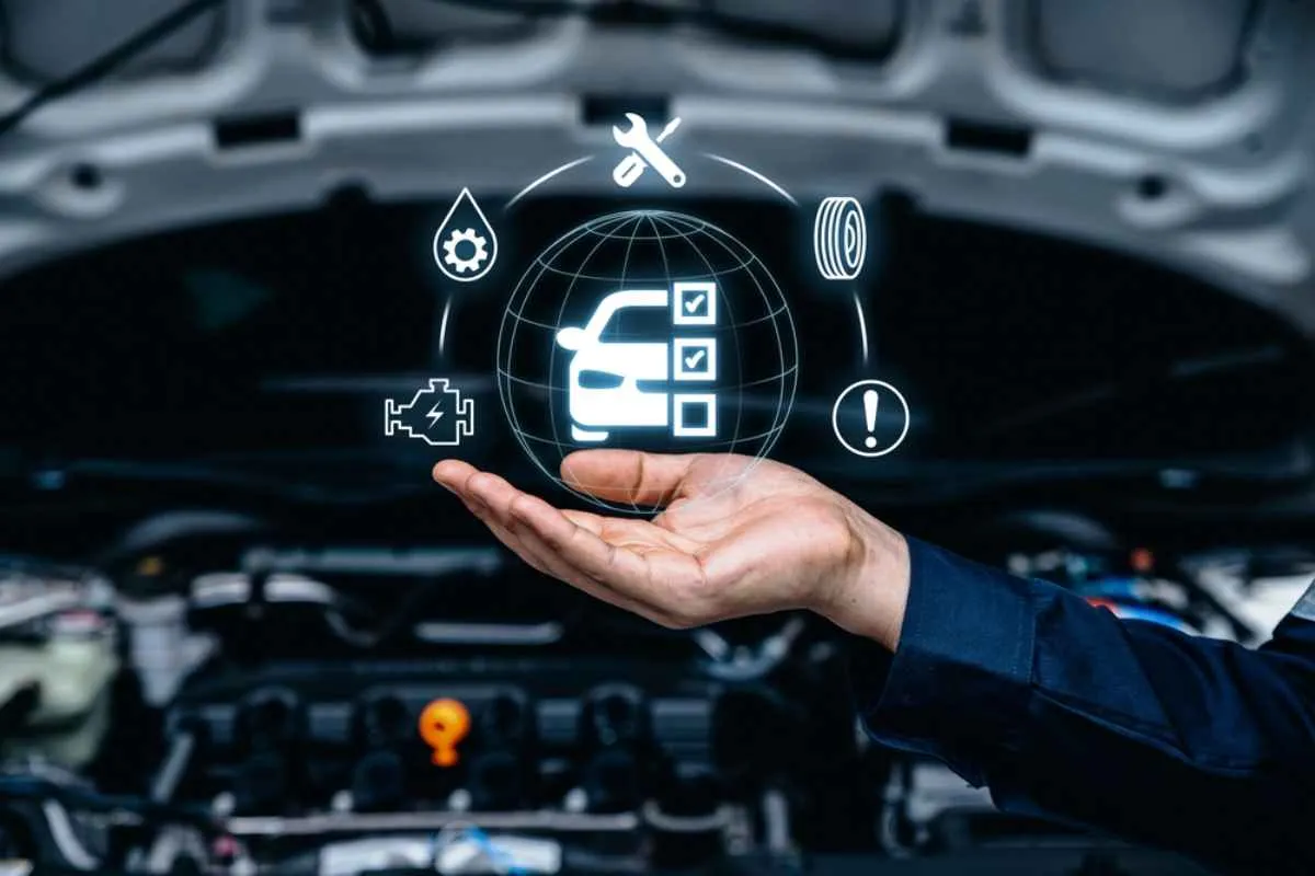 A vector image of what appears to be a mechanic's hand holding a luminous icon suspended in the air depicting the various vehicle insurance coverages.