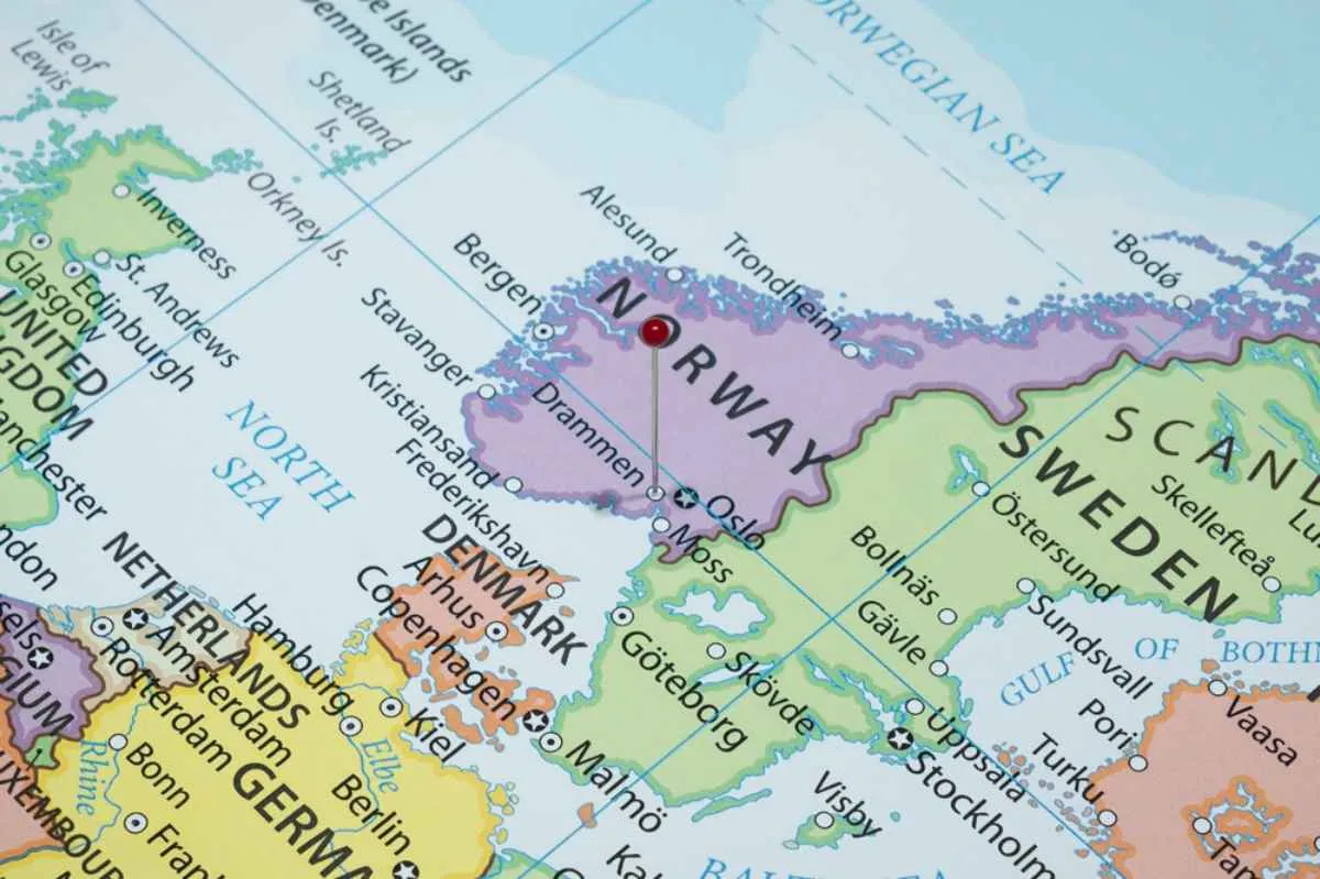 A political map of Norway and surrounding countries shows the city of Drammen with a pin.