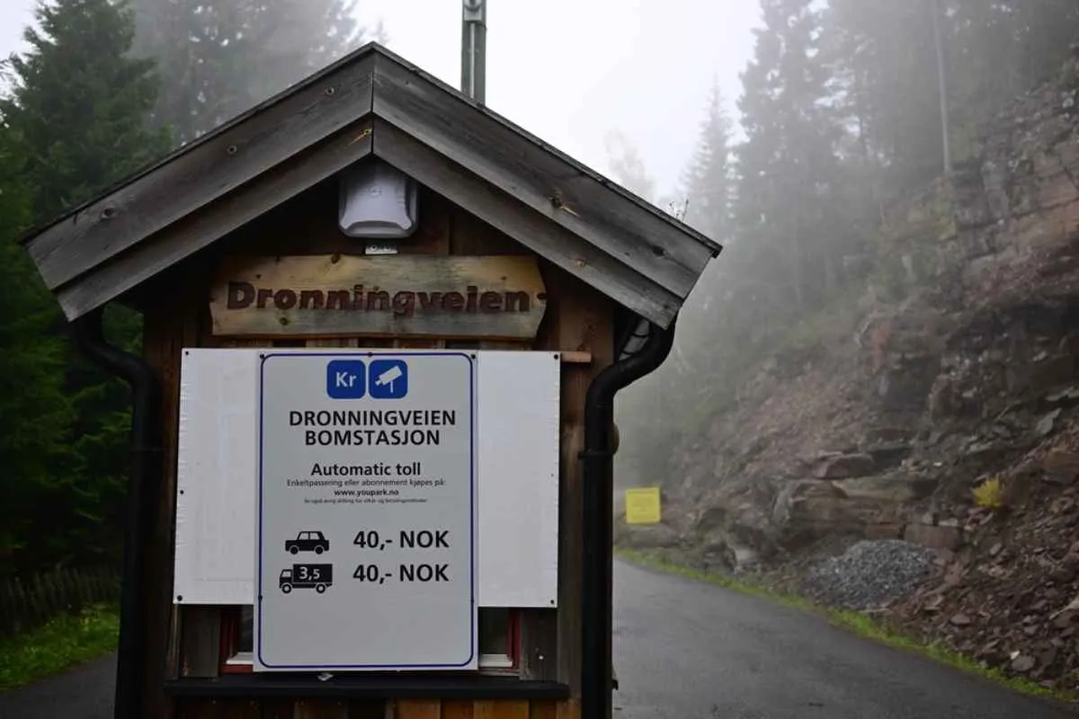 A sign at the gates of a toll road leading to a national park in Norway informs about the cost of the toll depending on the size of the vehicle.