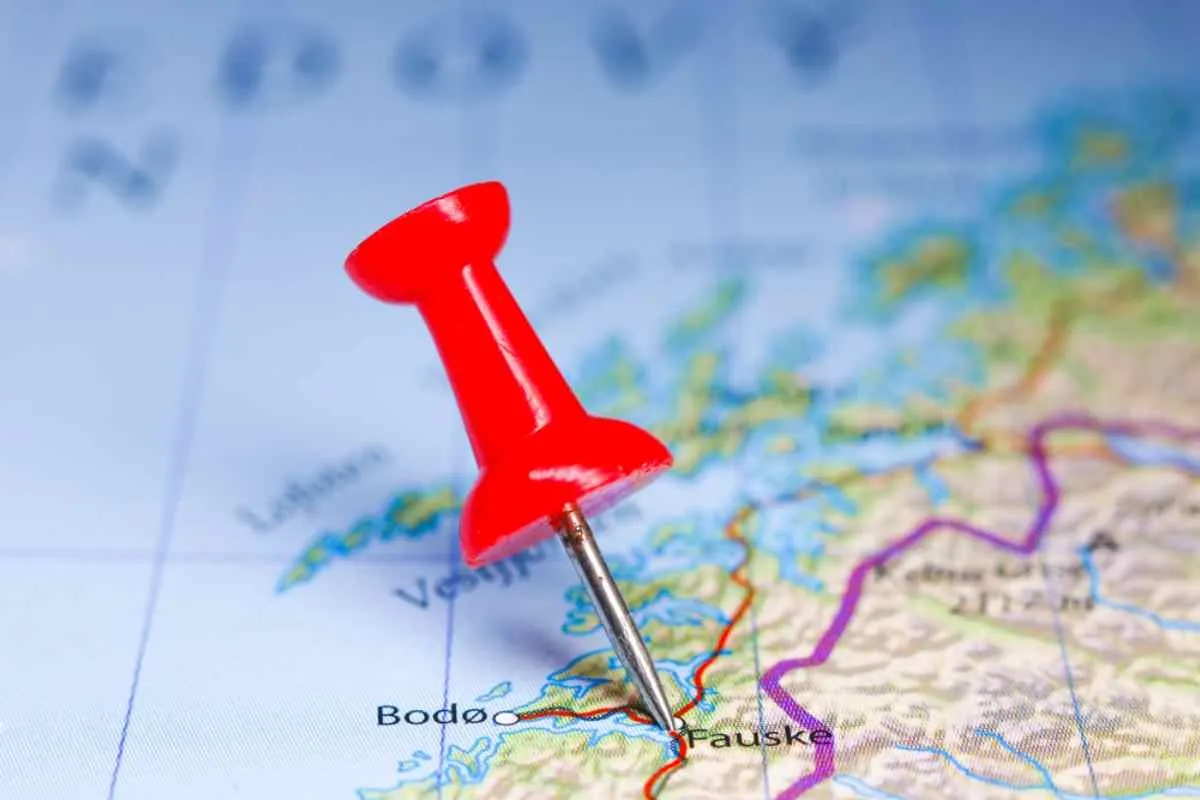 A pushpin points to the Norwegian town of Fauske on a political map of that country.
