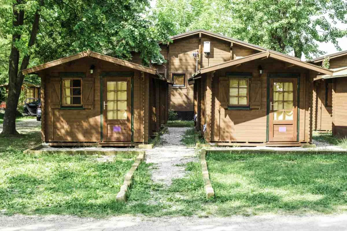 General view of the exterior of log cabins at a Norwegian campsite.