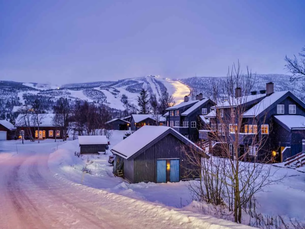 Beautiful winter picture of the small Norwegian village of Geilo with snow and wooden houses in the evening.