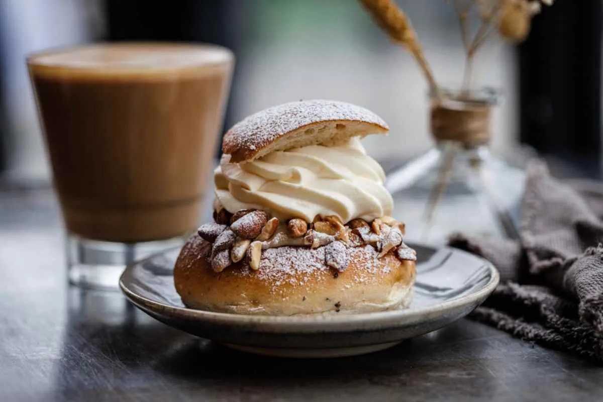 Primo piano su un tipico caffè svedese, chiamato «fika», e su un panino alla cannella.